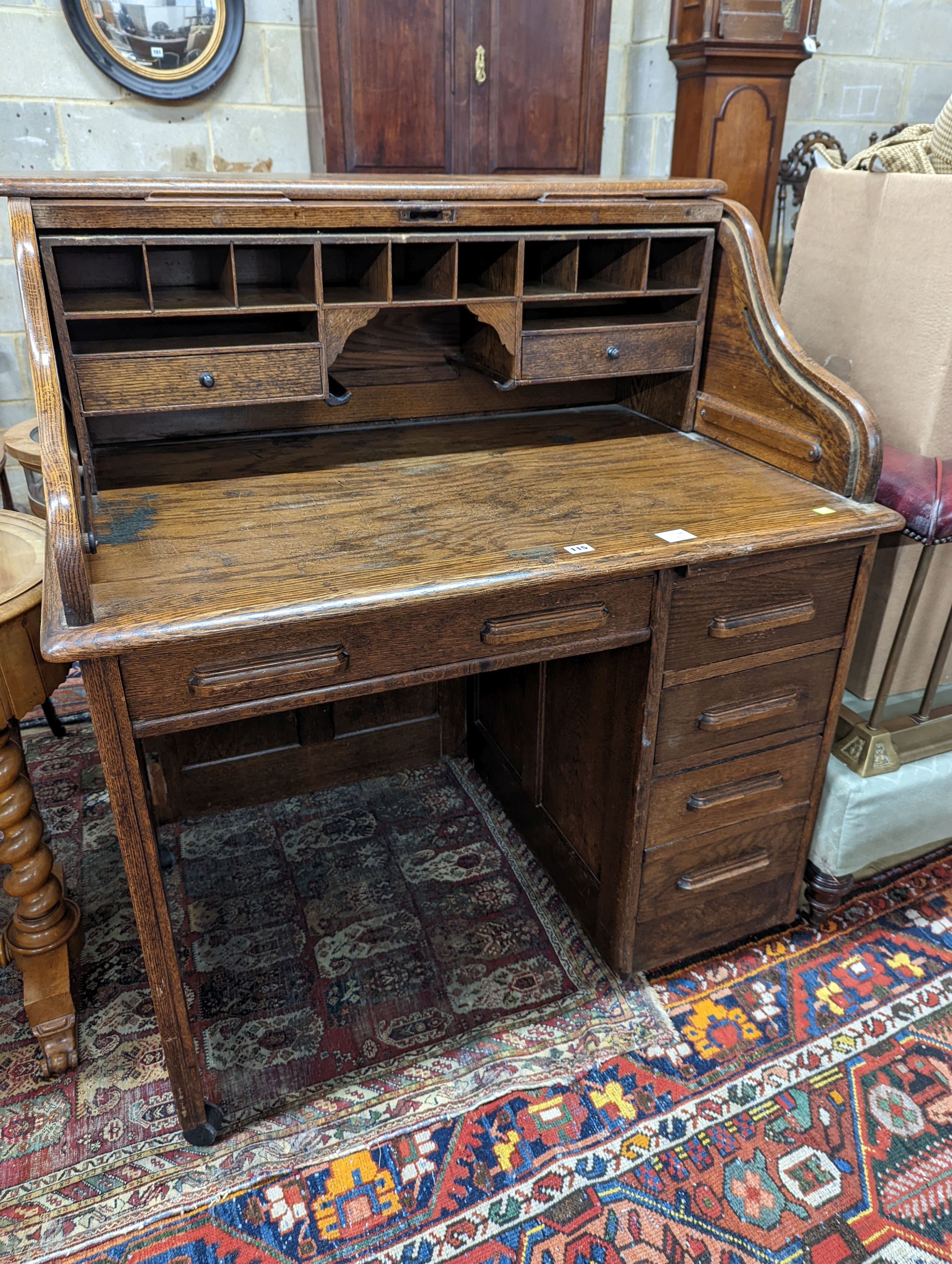 An early 20th century oak roll top desk with 'S' shaped tambour, width 106cm, depth 75cm, height 119cm